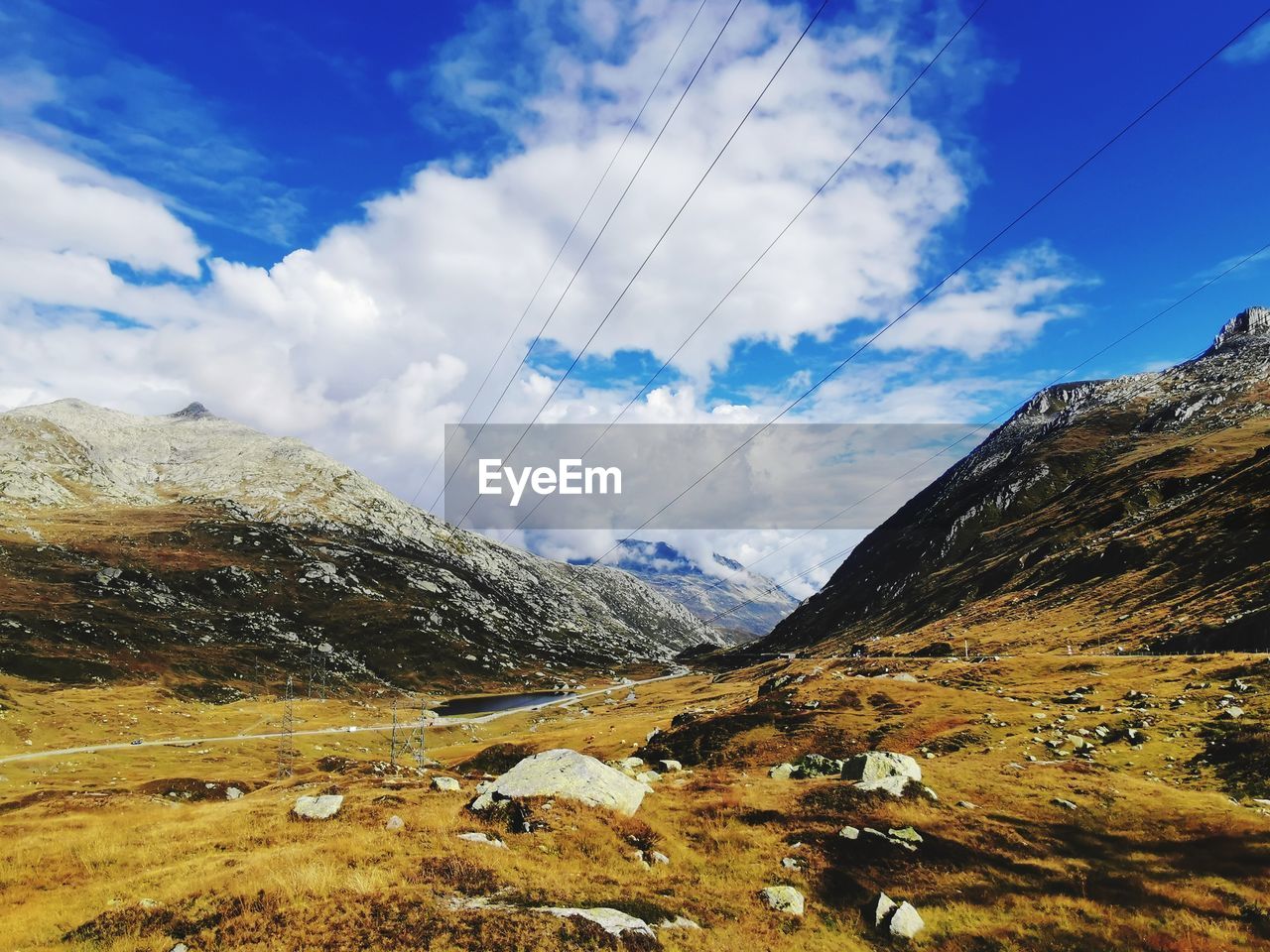 sky, cloud, mountain, scenics - nature, environment, landscape, mountain range, beauty in nature, nature, land, wilderness, tranquil scene, tranquility, non-urban scene, no people, valley, cable, day, travel, plateau, travel destinations, idyllic, outdoors, snow, blue, mountain pass, transportation, rock, electricity, ridge, remote, cold temperature