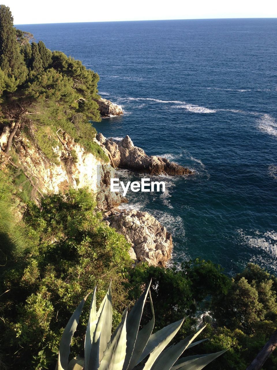 SCENIC VIEW OF SEA WITH ROCKS IN BACKGROUND