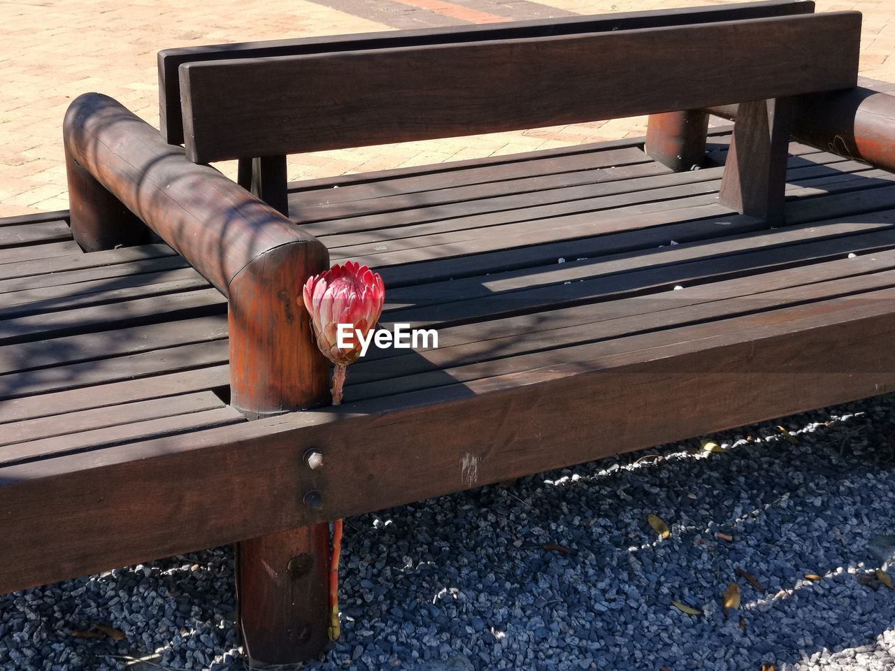 HIGH ANGLE VIEW OF BENCH BY RAILING