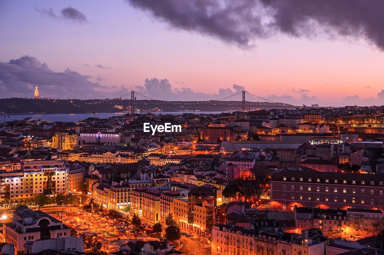 Illuminated cityscape against sky