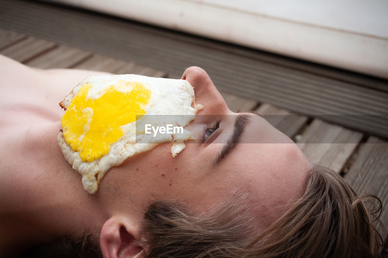 CLOSE-UP OF WOMAN HOLDING ICE CREAM OUTDOORS