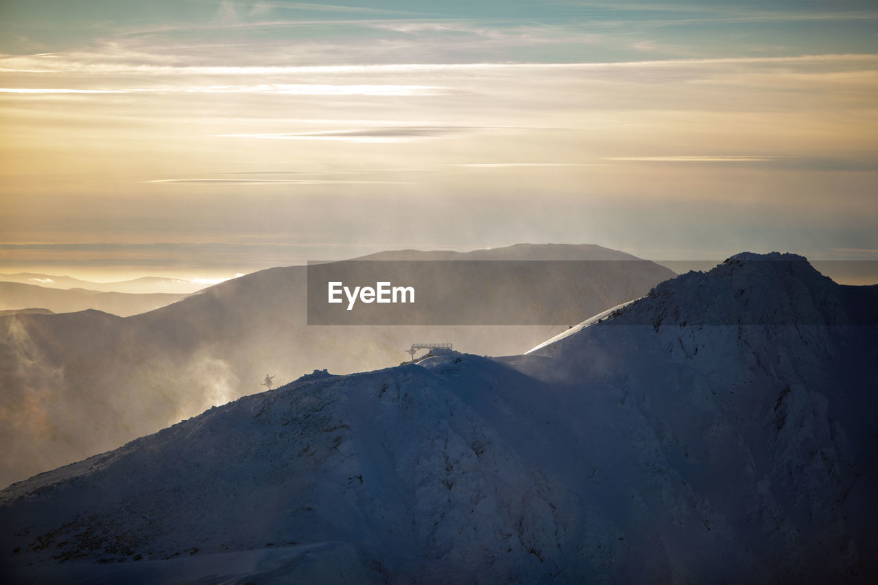 scenic view of snowcapped mountain against sky during sunset