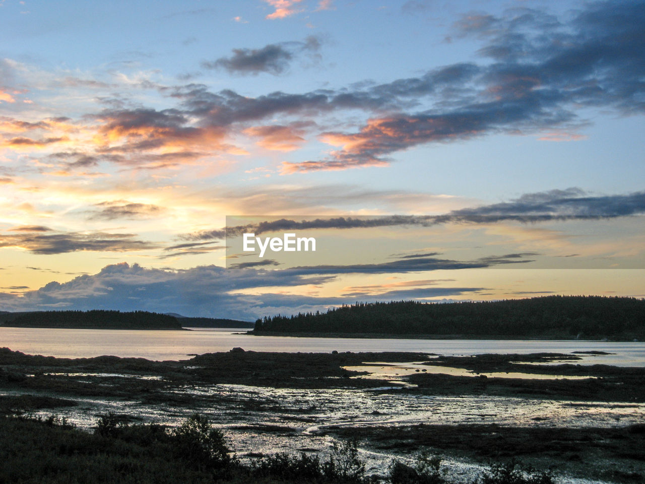 SCENIC VIEW OF SUNSET OVER CALM LAKE