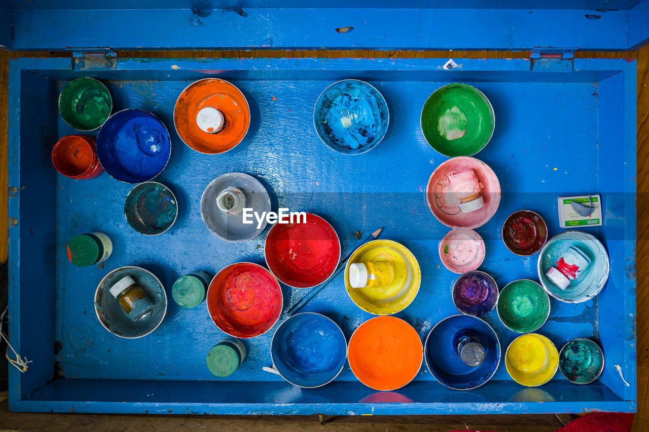 DIRECTLY ABOVE SHOT OF MULTI COLORED CANDIES IN BLUE CONTAINER