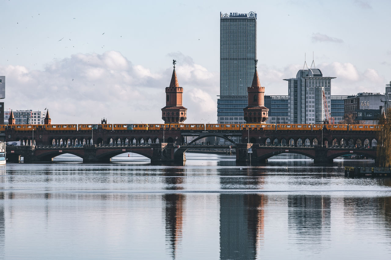 Bridge over river with buildings in background