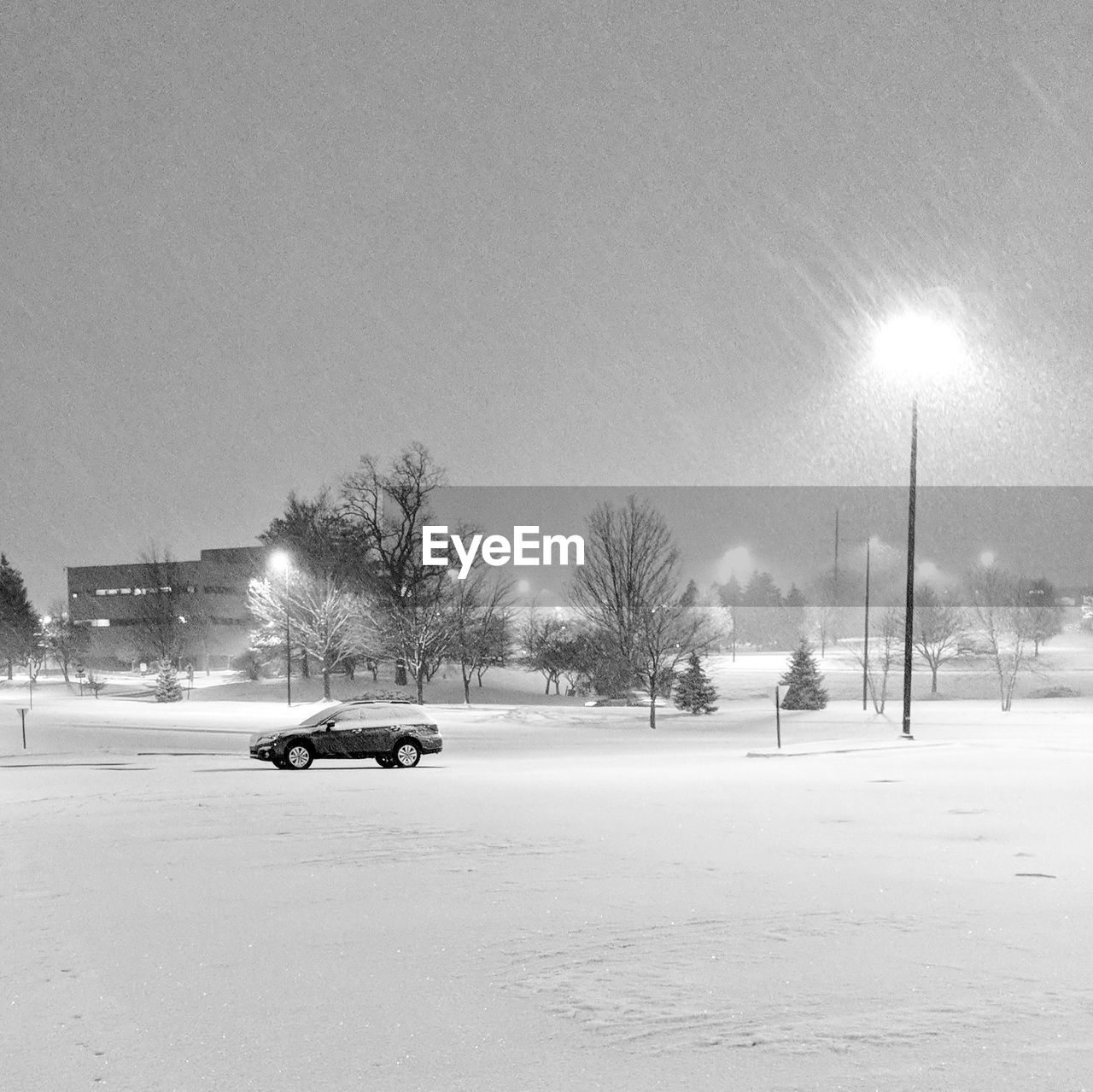 Cars on snow covered road against sky