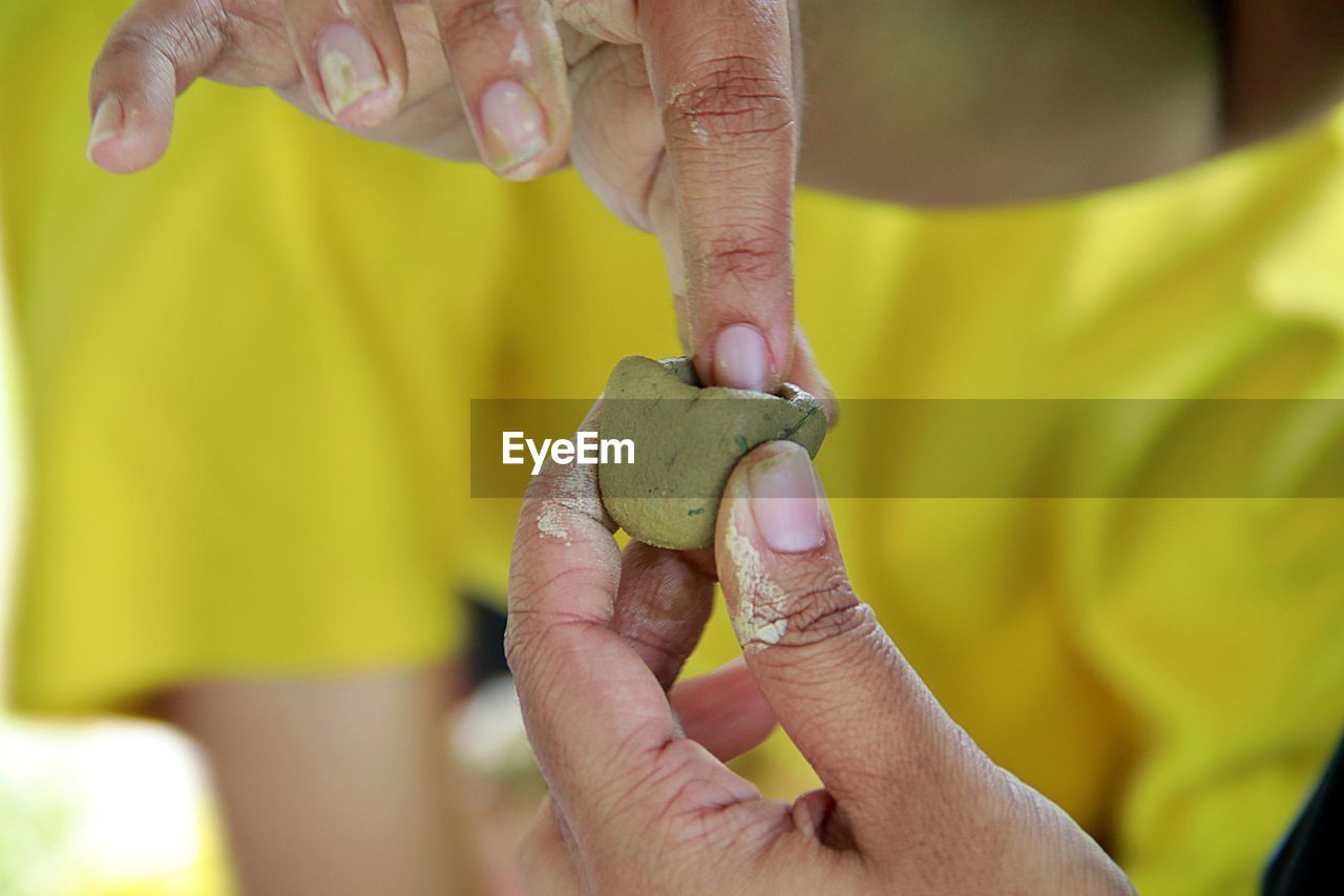 Close-up of man hand holding food