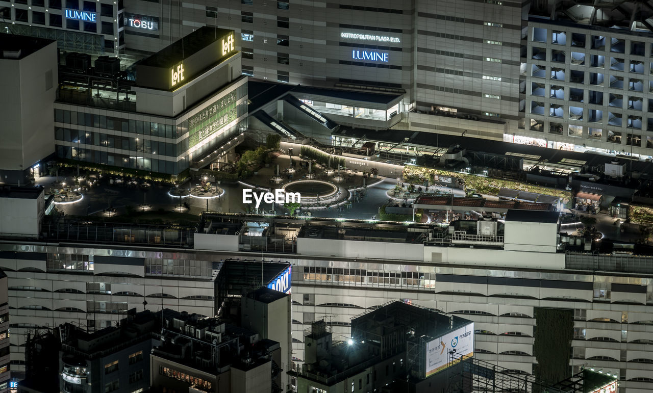 HIGH ANGLE VIEW OF ILLUMINATED CITY BUILDINGS