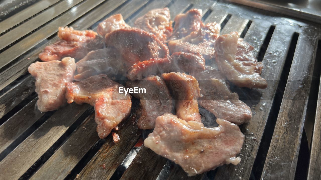 food, food and drink, meat, freshness, barbecue, barbecue grill, cooking, grilled, grilling, heat, dish, high angle view, no people, preparing food, outdoor grill, cuisine, roasting, still life, horumonyaki, metal, close-up, red meat, unhealthy eating, fast food, day, outdoors, pork
