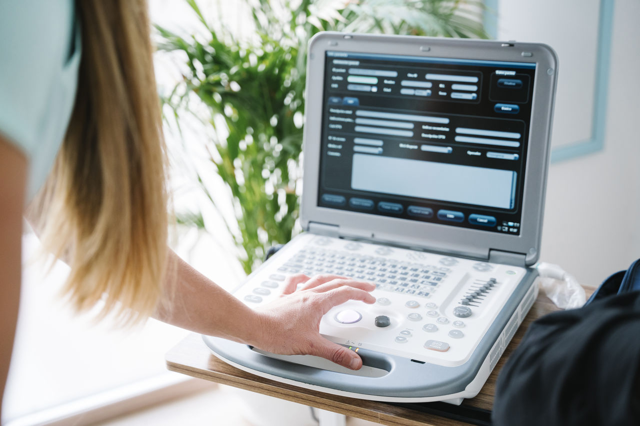 Female nurse using monitoring equipment