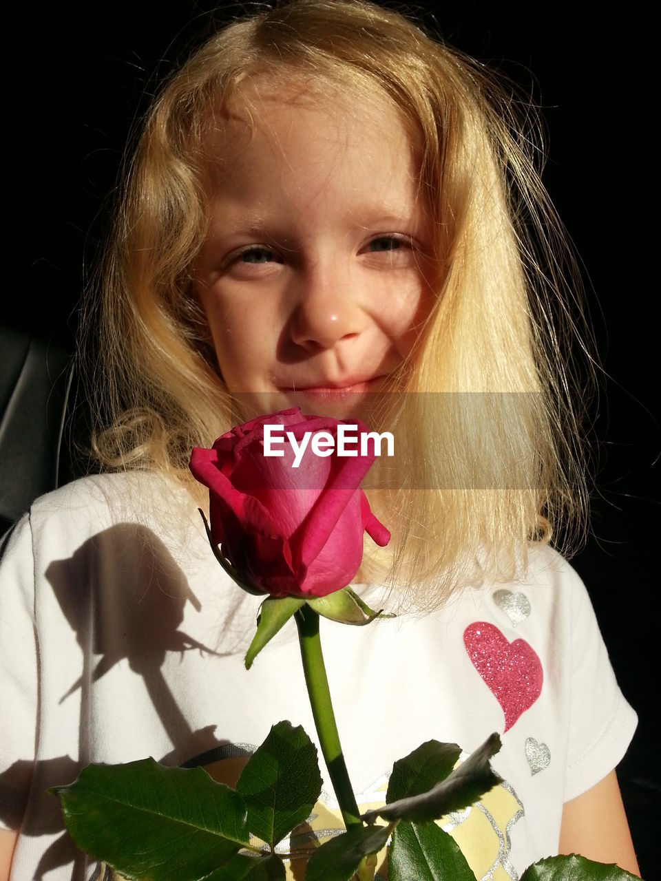 Portrait of woman holding pink flower