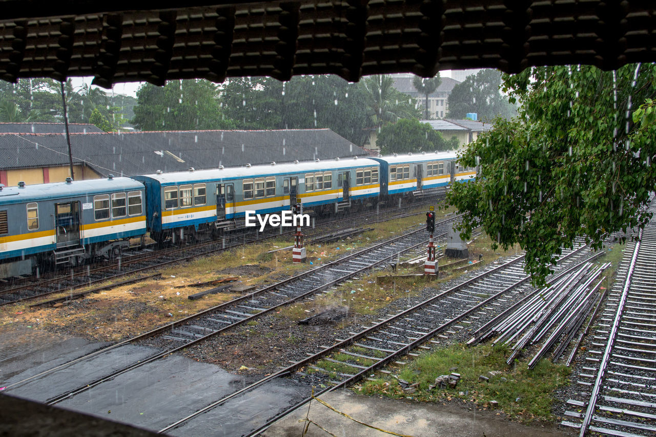 Train seen through window during rainy season