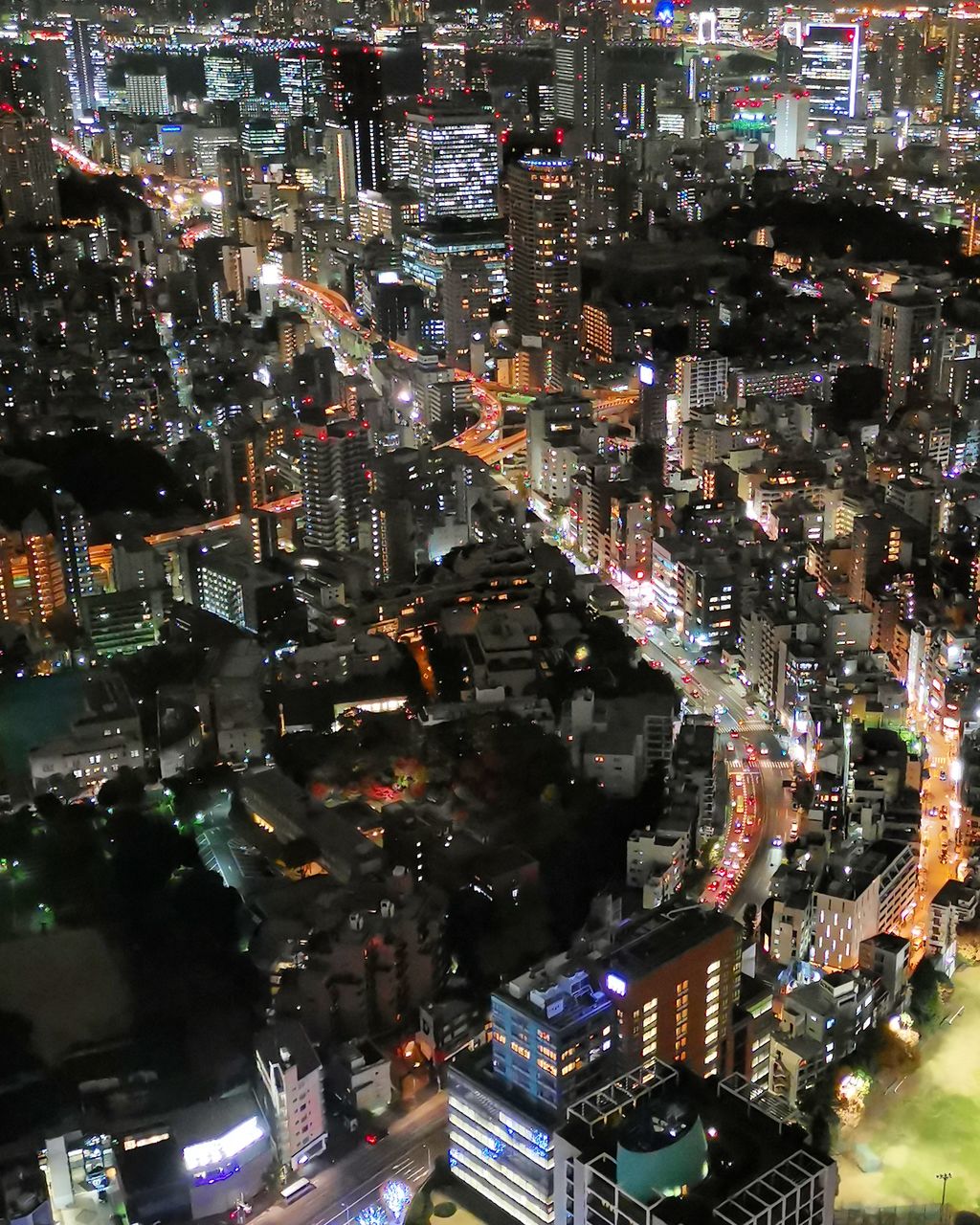 HIGH ANGLE VIEW OF ILLUMINATED CITY BUILDINGS