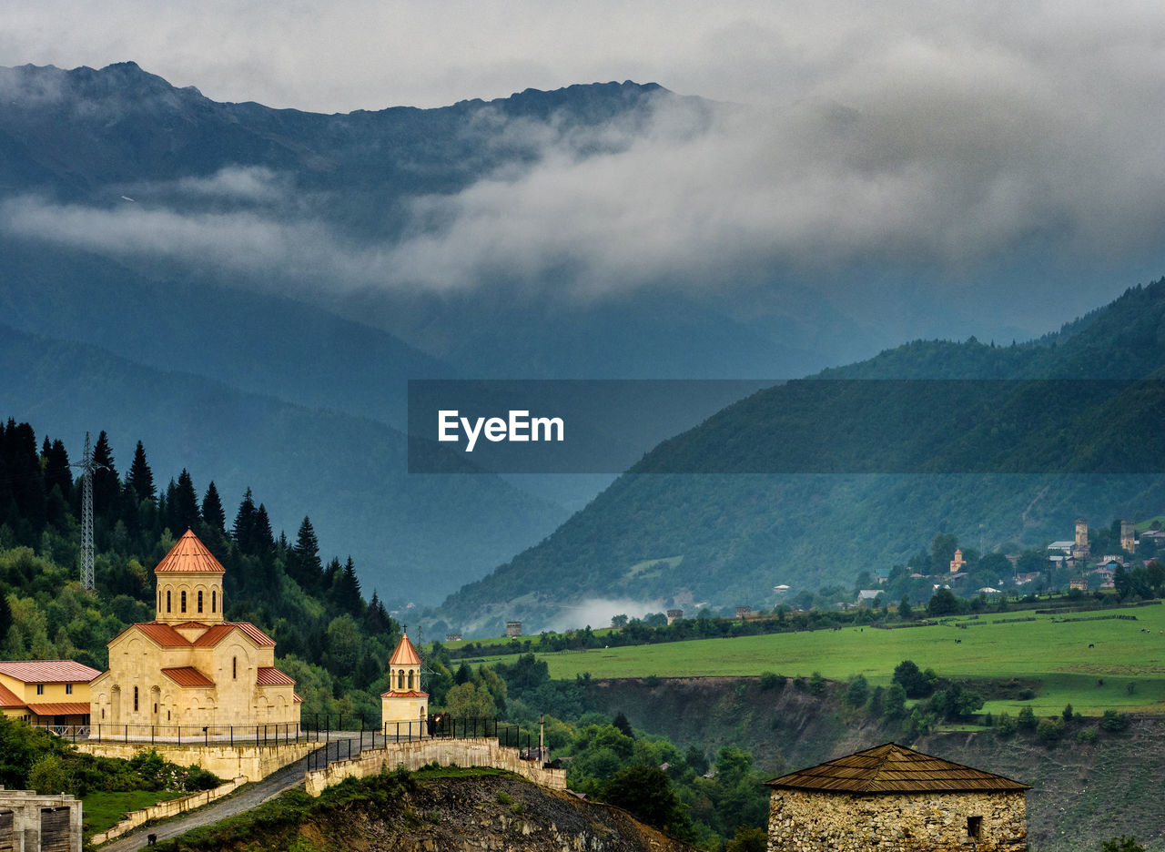 Scenic view of mountains against cloudy sky