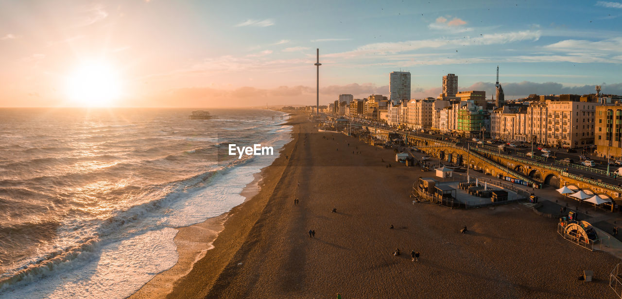 Magical sunset aerial view of british airways i360 viewing tower pod with tourists in brighton