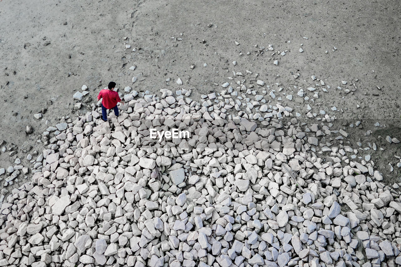 High angle view of man walking on rocks