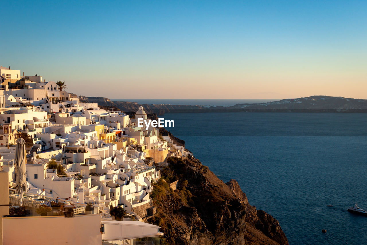 Fira in the rays of the setting sun. santorini, greece.