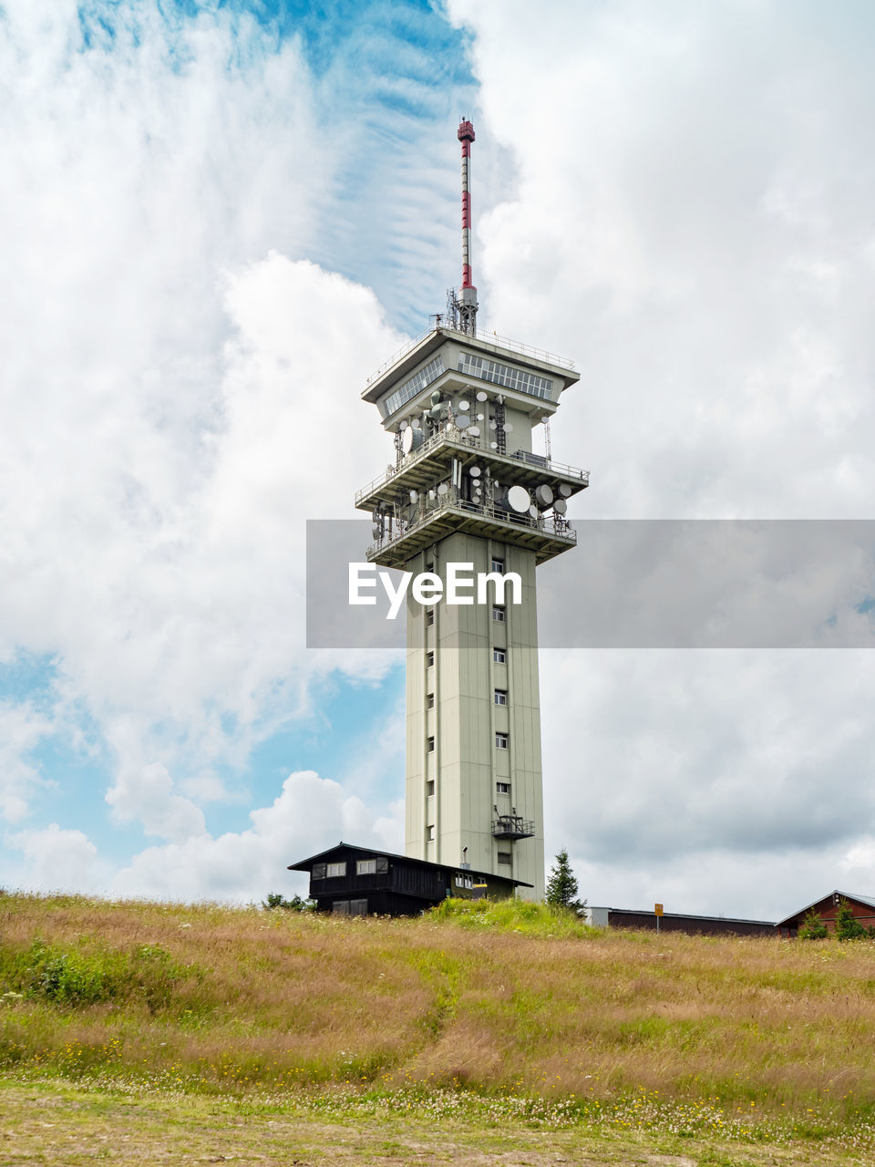 Old transmission tower on the klinovec mountain with clouds in backgground. ore mountains, czechia