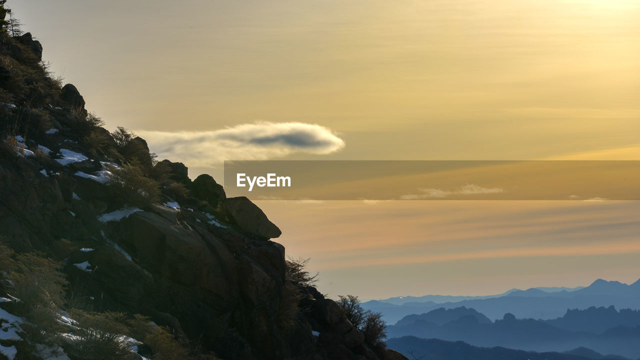 sky, mountain, sunset, scenics - nature, beauty in nature, environment, cloud, mountain range, landscape, nature, tranquility, sun, tranquil scene, rock, travel, mountain peak, dawn, sunlight, land, dramatic sky, travel destinations, outdoors, idyllic, no people, silhouette, non-urban scene, fog, horizon, twilight, activity, adventure, back lit, cold temperature, tourism, winter, tree, awe