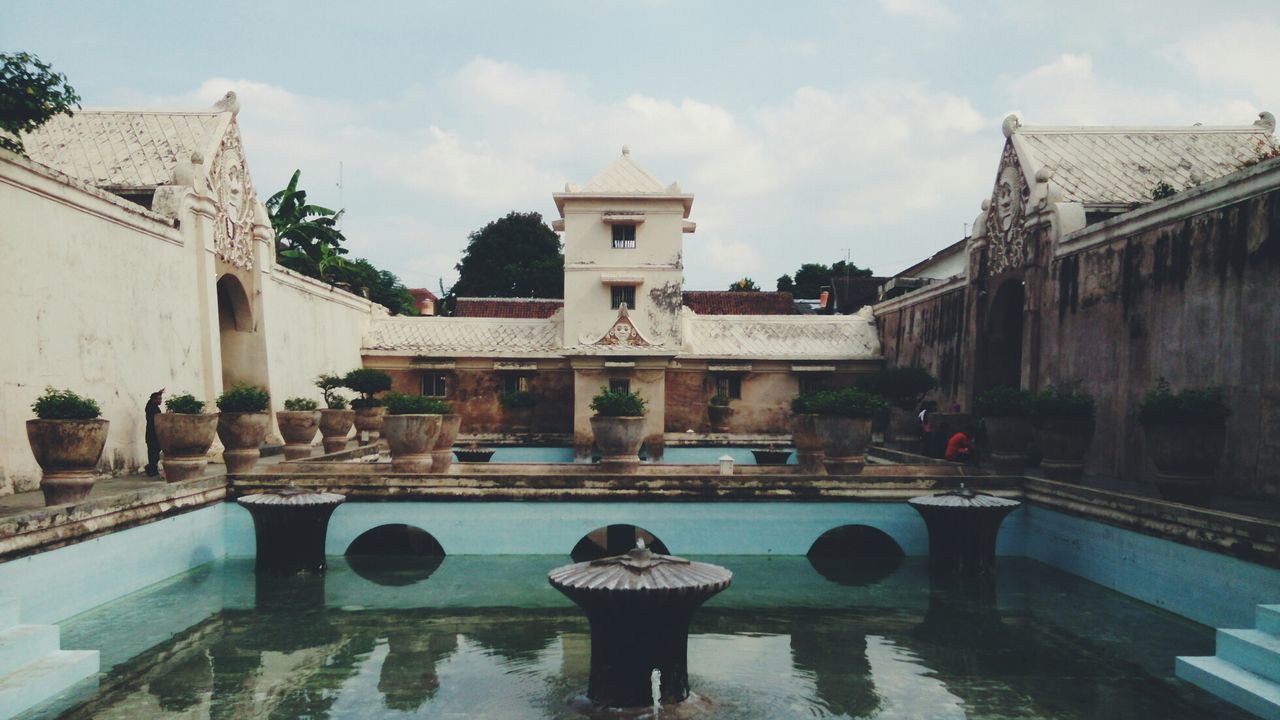 Built structure with pond in foreground