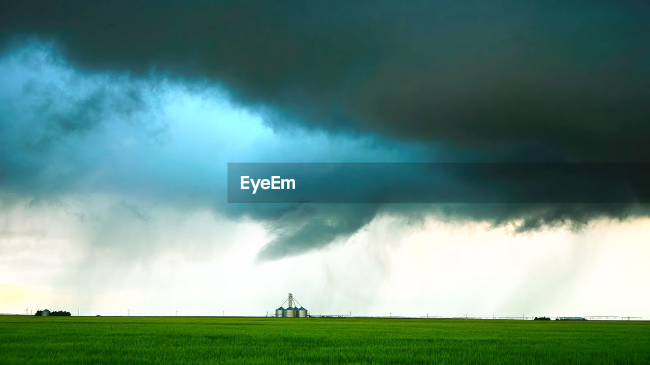 environment, storm, cloud, thunderstorm, sky, thunder, landscape, beauty in nature, nature, storm cloud, grass, land, power in nature, dramatic sky, field, plant, green, wet, rain, warning sign, outdoors, extreme weather, scenics - nature, rural scene, no people