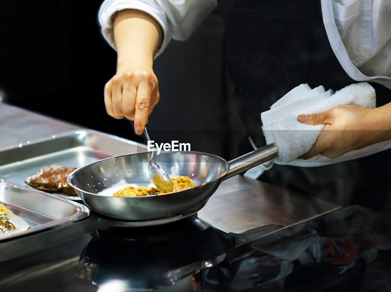 midsection of man preparing food in kitchen