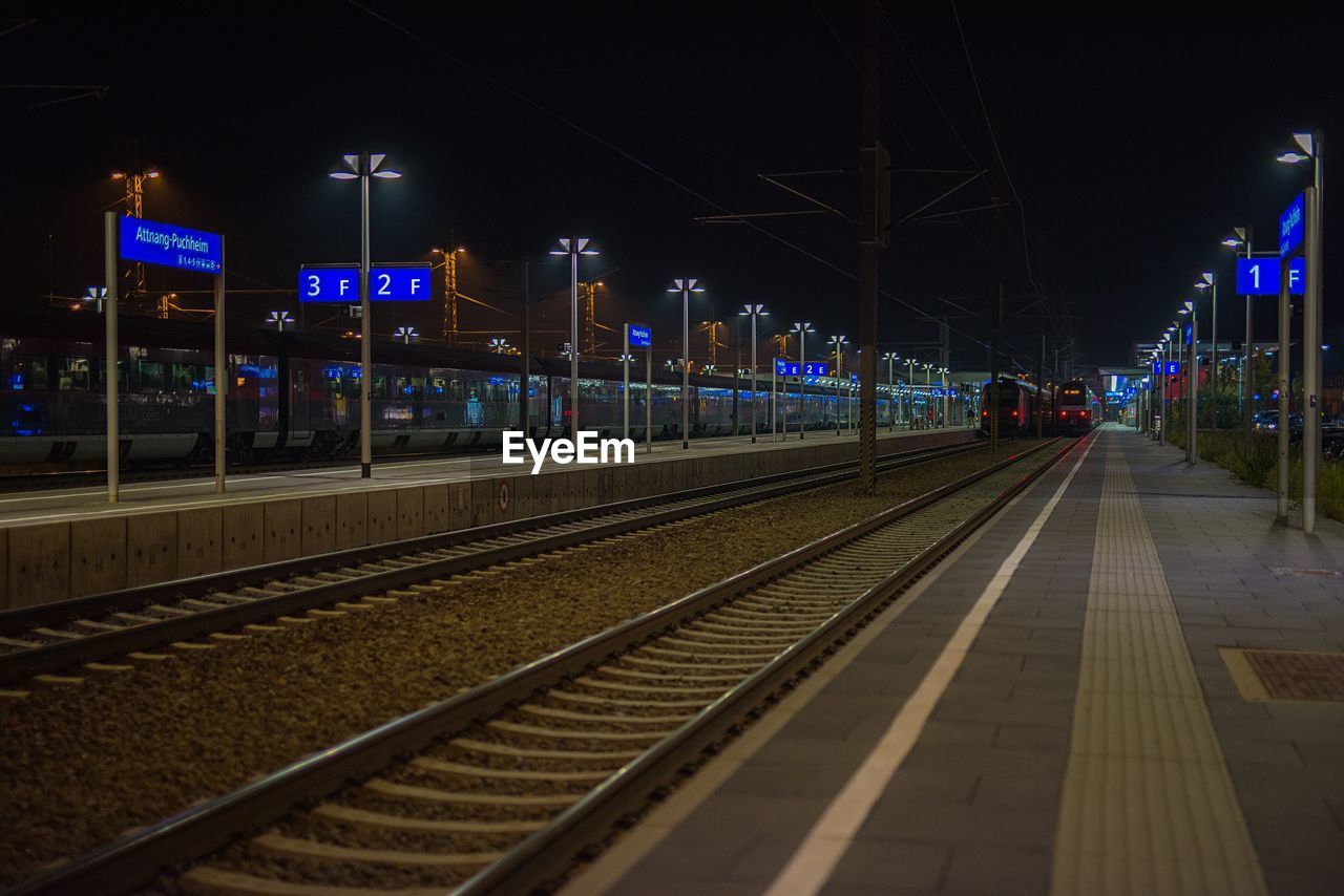 ILLUMINATED RAILROAD STATION PLATFORM AT NIGHT