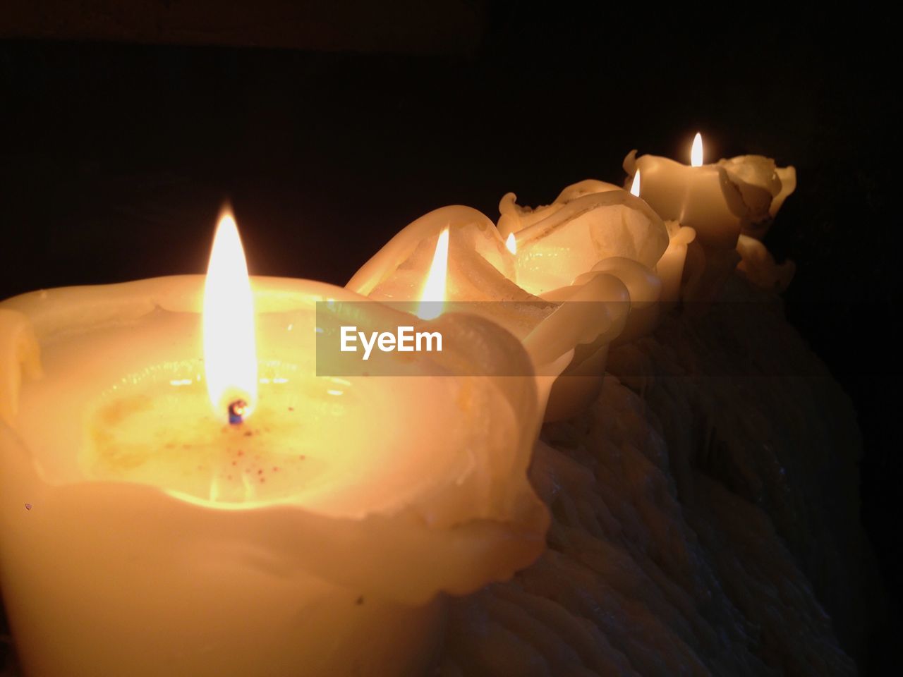 CLOSE-UP OF LIT CANDLE