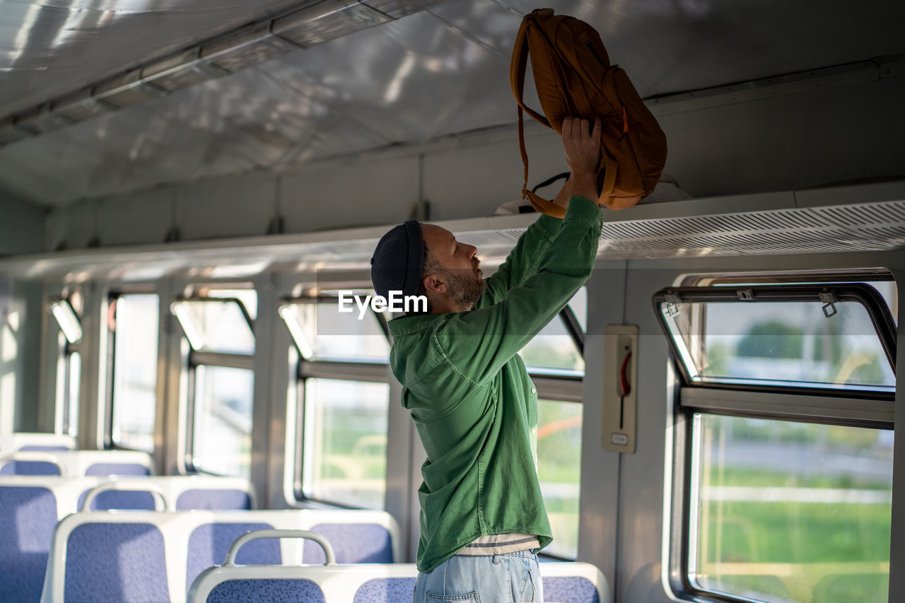 rear view of woman standing in bus