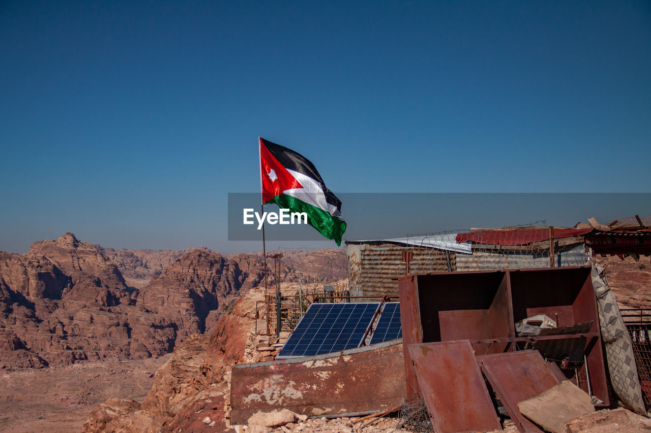 FLAG AGAINST BLUE SKY AND BUILDING