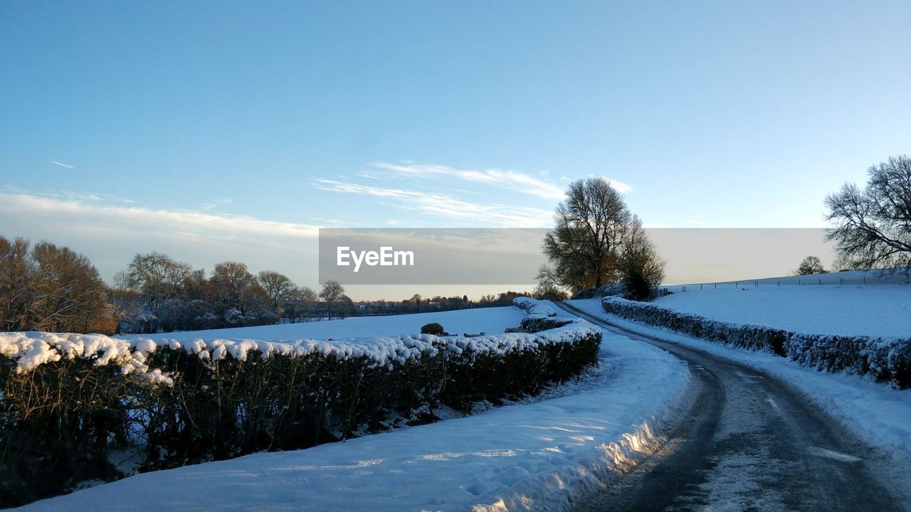 Snow covered landscape against sky