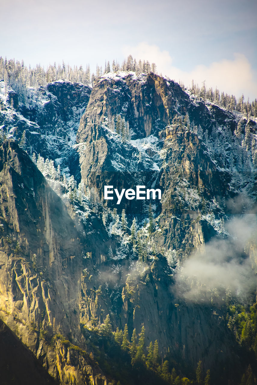 Aerial view of snowcapped mountains against sky