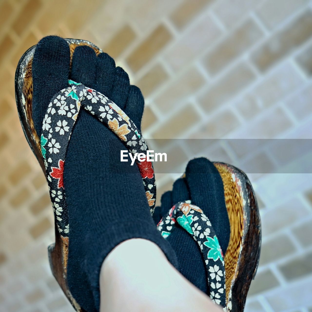 Low section of person standing by canvas shoes