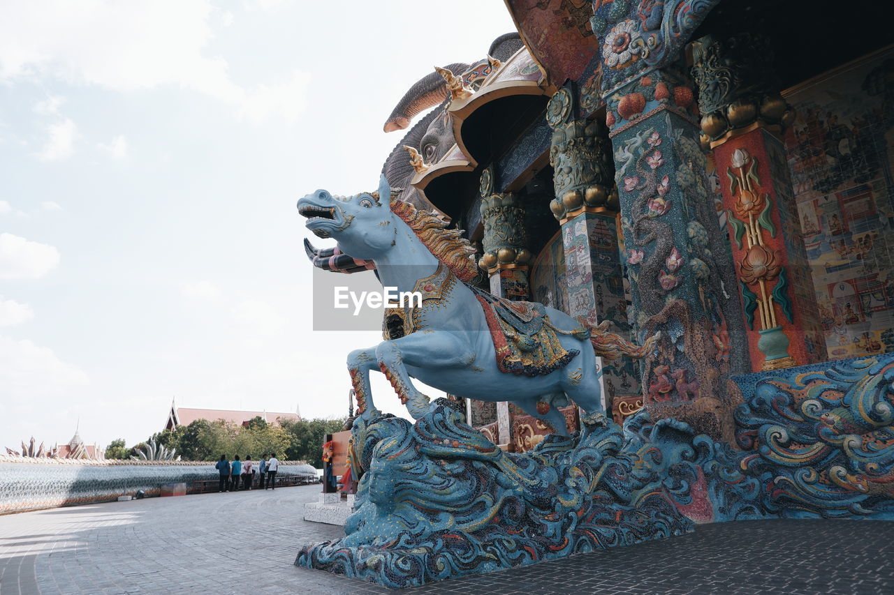 STATUE OF BUDDHA AGAINST SKY