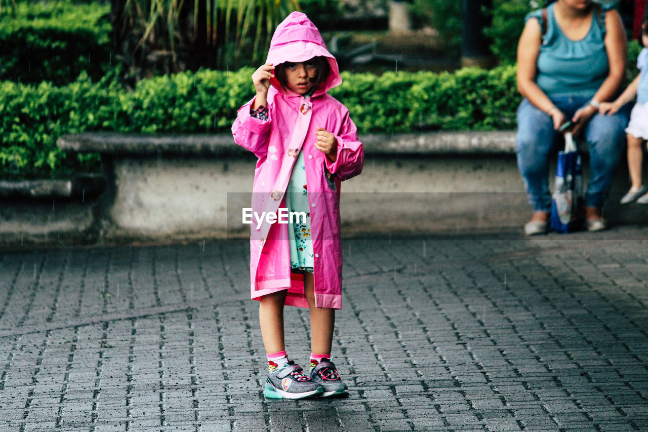 FULL LENGTH OF WOMAN WITH PINK UMBRELLA STANDING ON GROUND