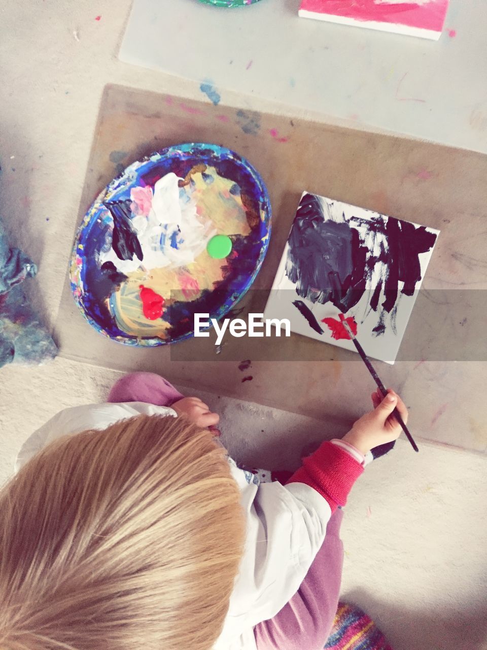 High angle view of girl painting at home