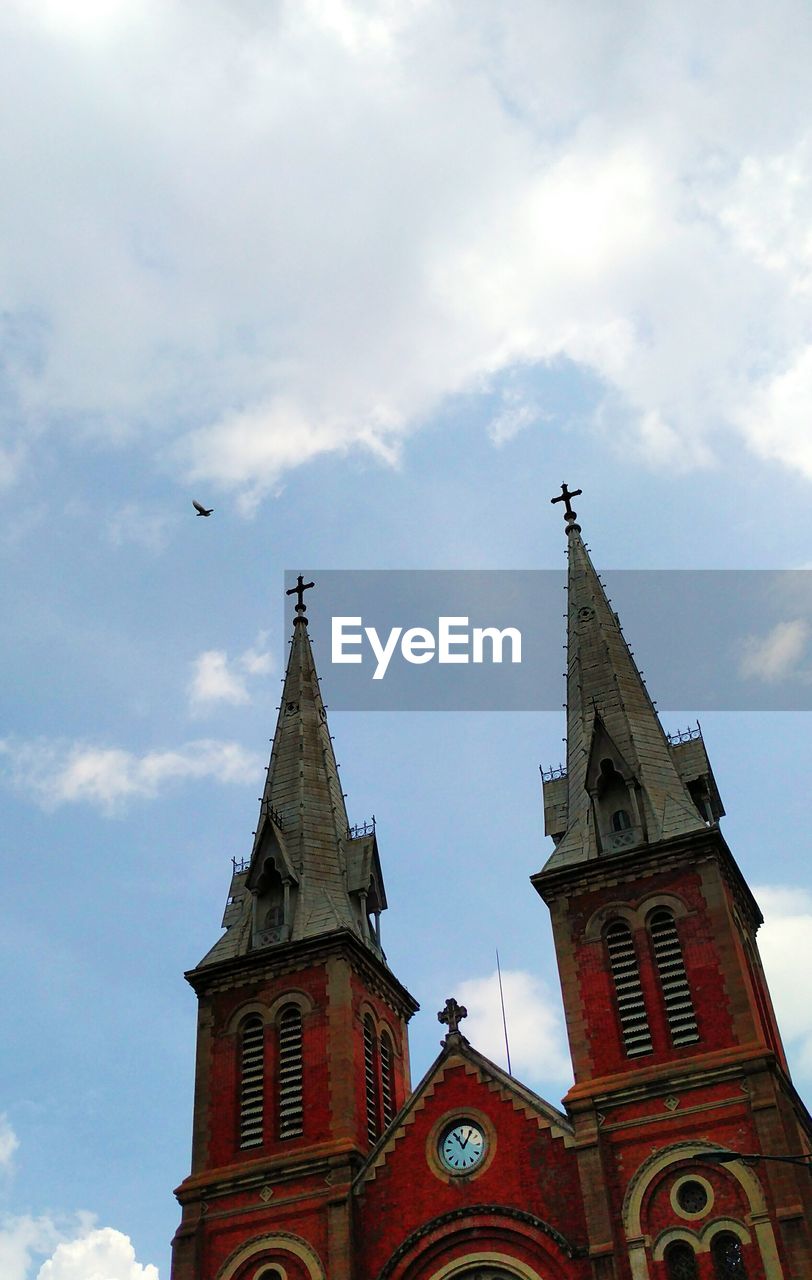 Low angle view of bell tower against sky