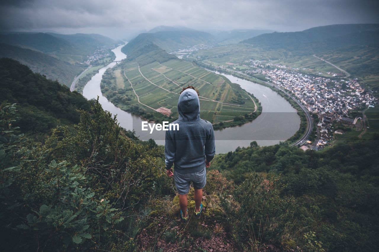 Rear view of woman on mountain against sky