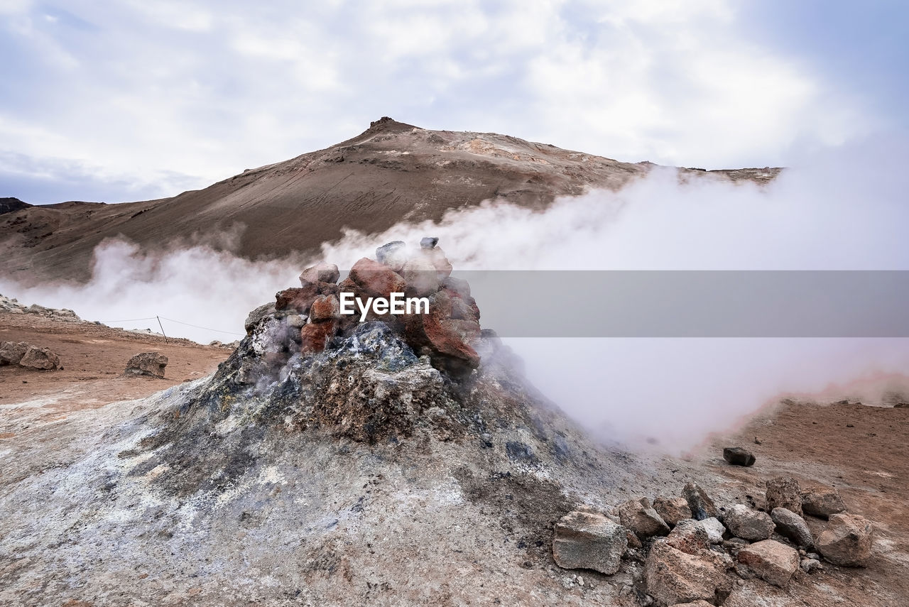 Steam emitting from fumarole in geothermal area of hverir at namafjall