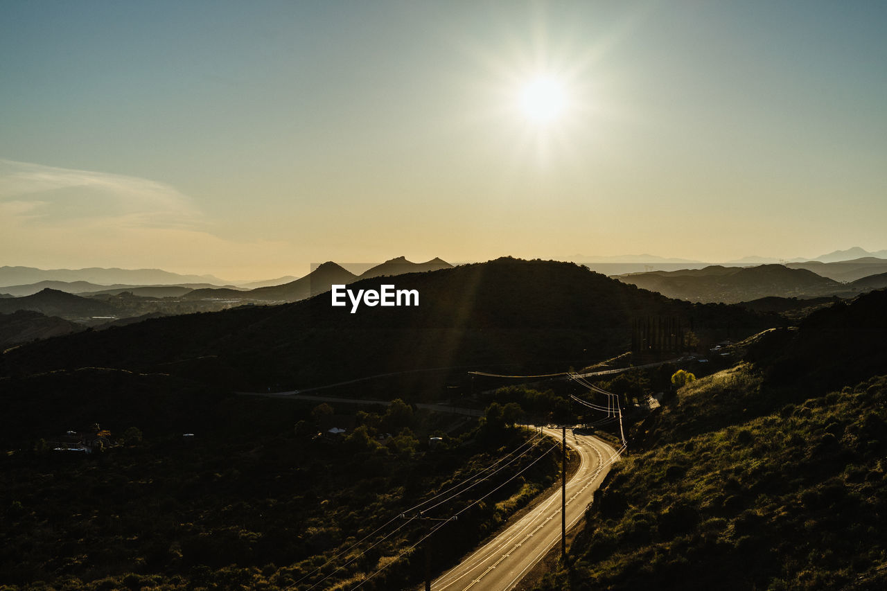 SCENIC VIEW OF MOUNTAIN AGAINST SKY AT SUNSET