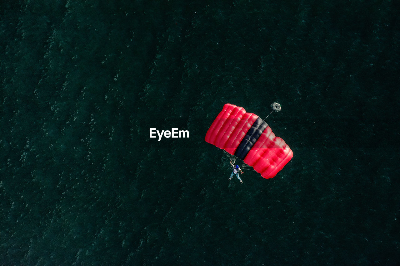 High angle view of man paragliding over sea