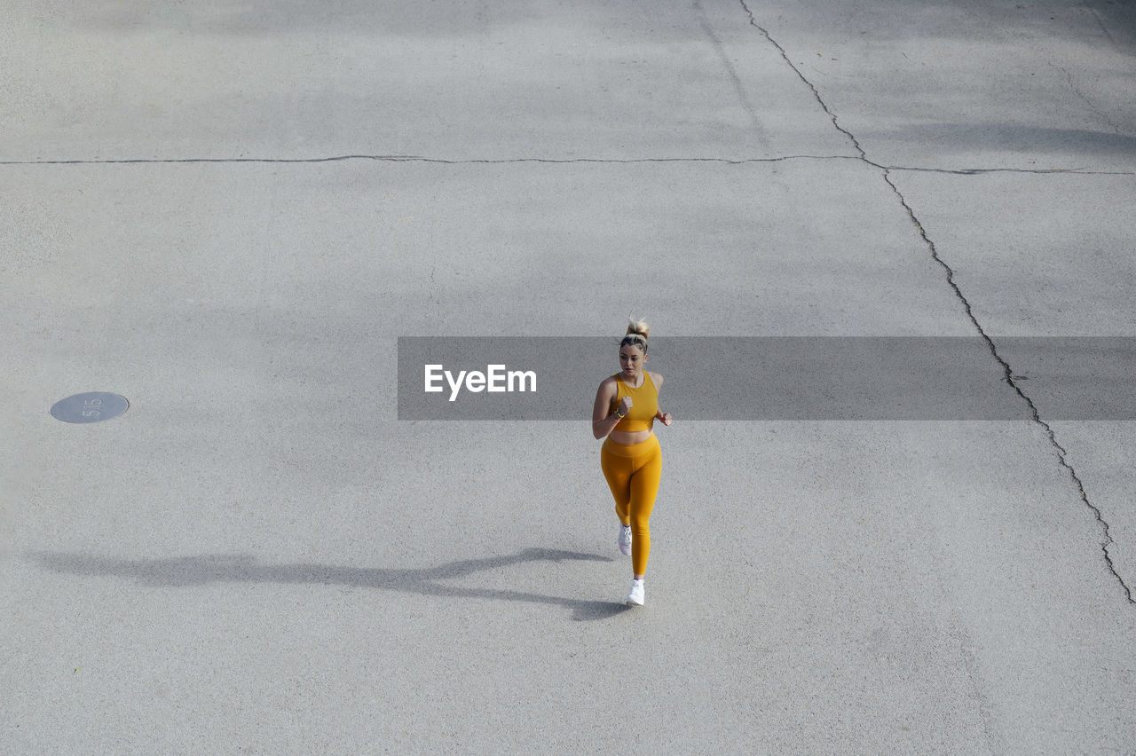 Young athlete jogging on road