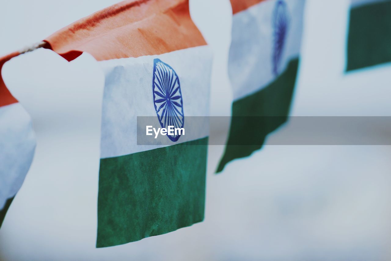 Close-up of indian flags against sky