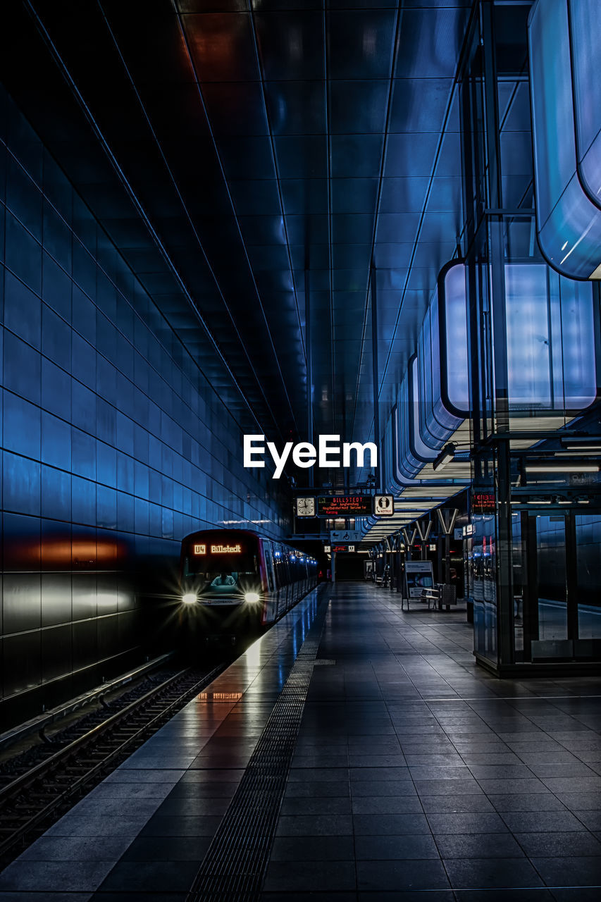 TRAIN AT RAILROAD STATION AGAINST SKY