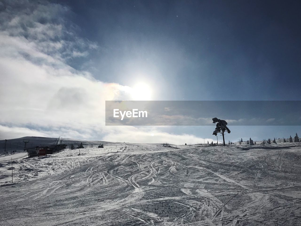 PERSON ON SNOW COVERED LAND AGAINST SKY