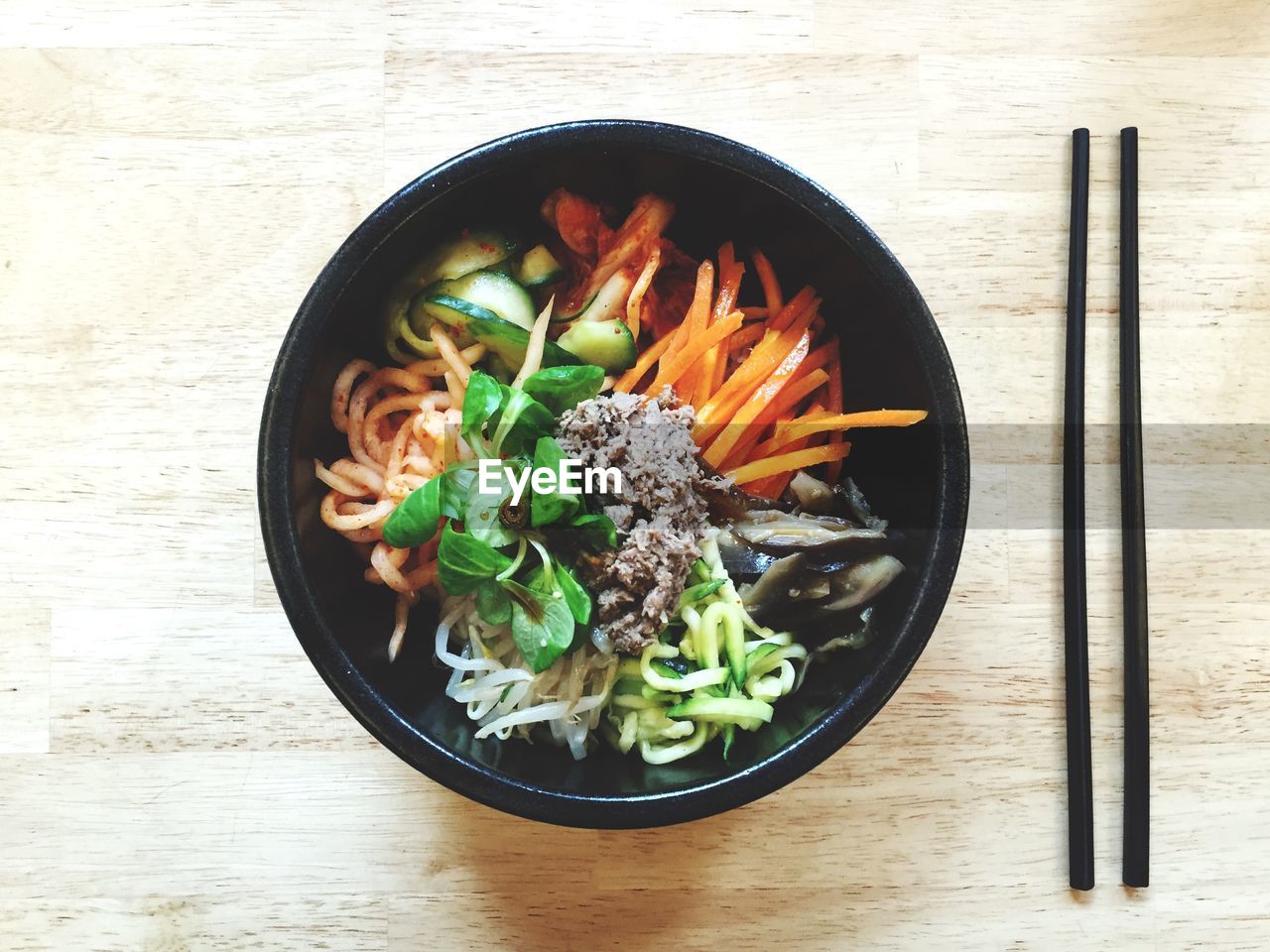 Directly above shot of bi bim bap served in bowl on table