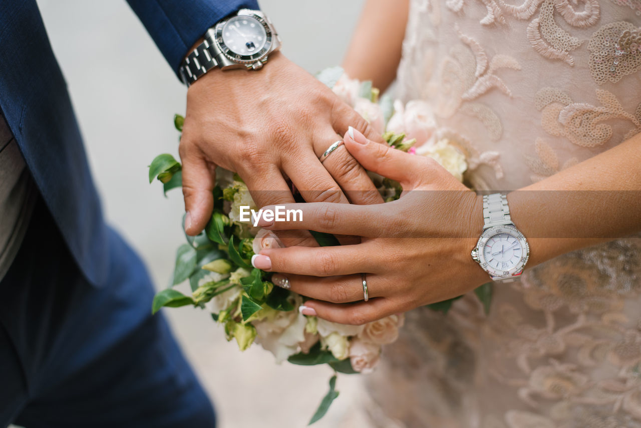 Wedding bouquet in the hands of the bride and groom