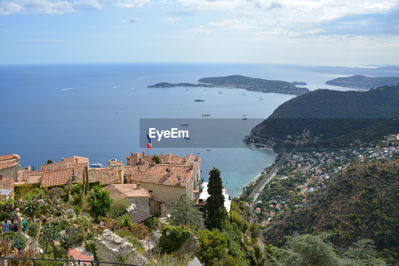 High angle view of buildings and sea against sky