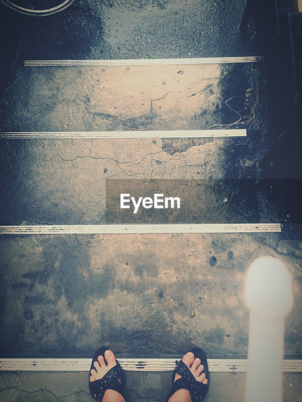 Directly above view of woman standing on steps in shinsen station