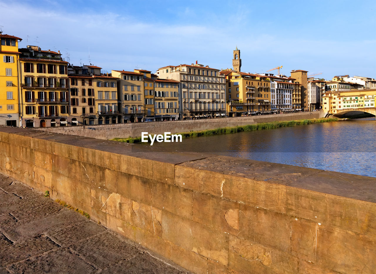 Buildings by arno river seen from ponte santa trinita in tuscany